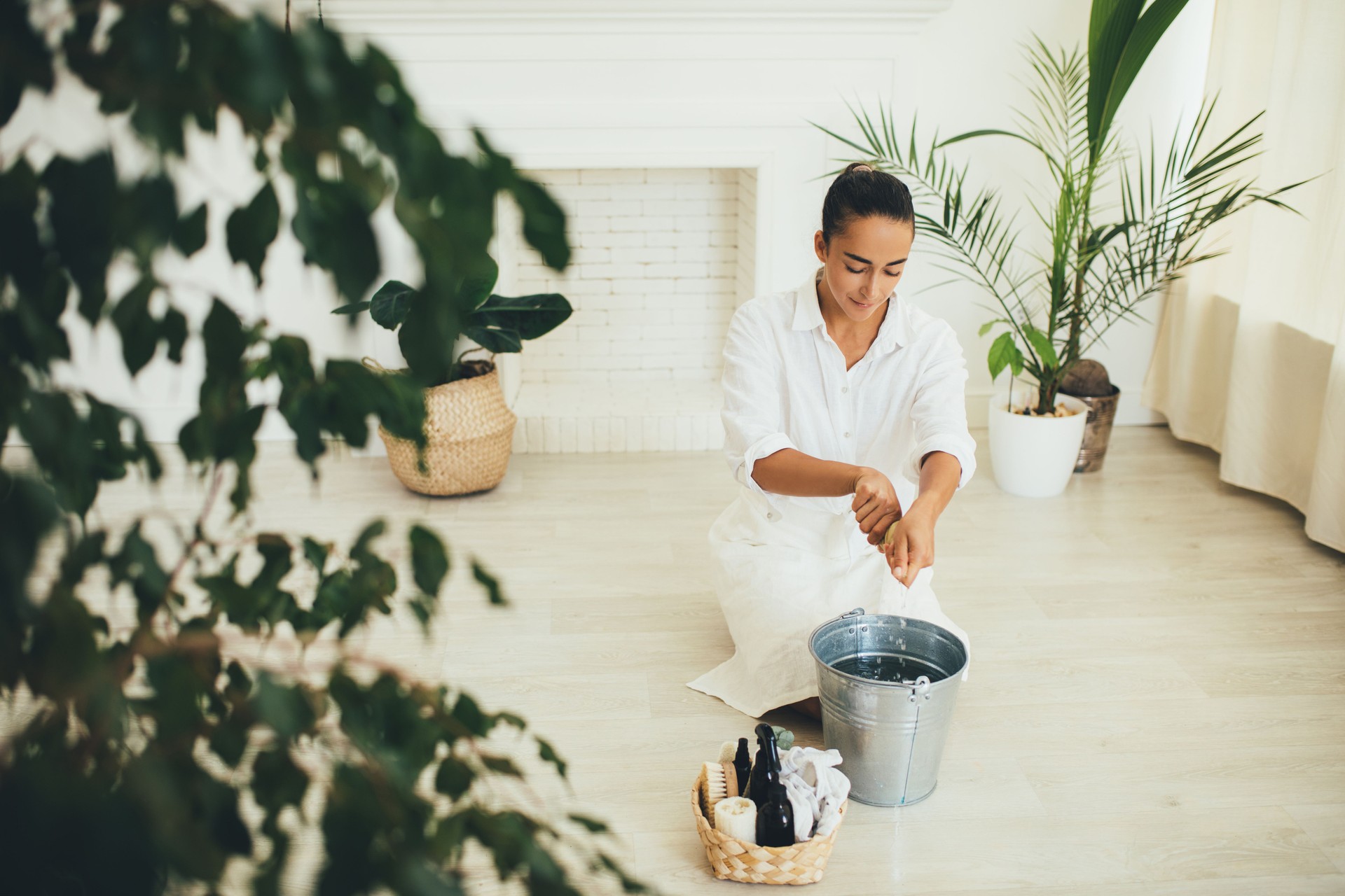 Young woman cleaning room using natural wooden brush. Sustainable eco friendly tools for cleaning.